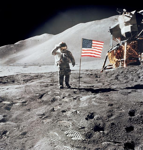 An astronaut on the moon with a USA flag
