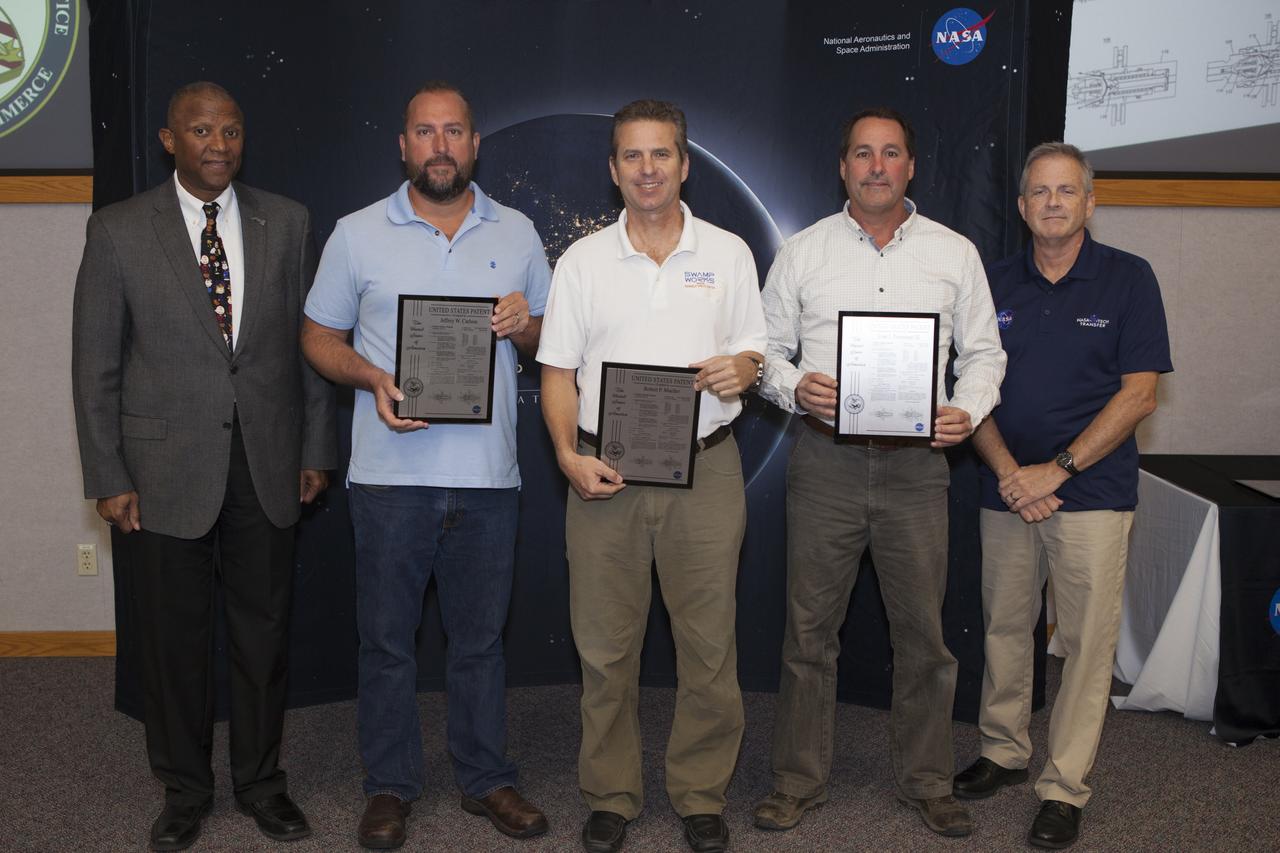 U.S. Patent plaques awarded for the invention of Dust and Debris Tolerant Dual Poppet Valve Connector, during the 2017 Innovation Expo at NASA's Kennedy Space Center in Florida.