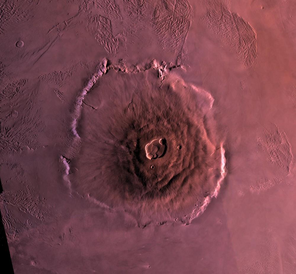 An orbital view of Olympus Mons on Mars, the largest volcano in the solar system. Such colossal shield volcanoes result from Mars’s long-lived, stationary hotspots and lack of plate tectonics.