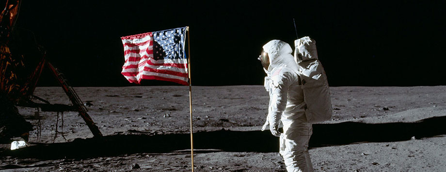 Astronaut walking on the Moon surface with USA flag