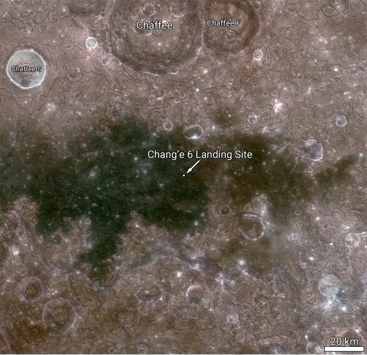 A regional context map of the Chang’e 6 landing site. The dark area is a basaltic mare deposit; bluer areas of the mare are higher-titanium flows. Contour lines marking 100-meter (about 328 feet) elevation intervals are overlaid to provide a sense of the topography. The image is about 118 miles (190 km) across. Credit: NASA/Goddard